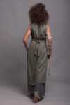 Back view of the LINAS apron dress, emphasizing the natural flow of medium-weight linen fabric.
