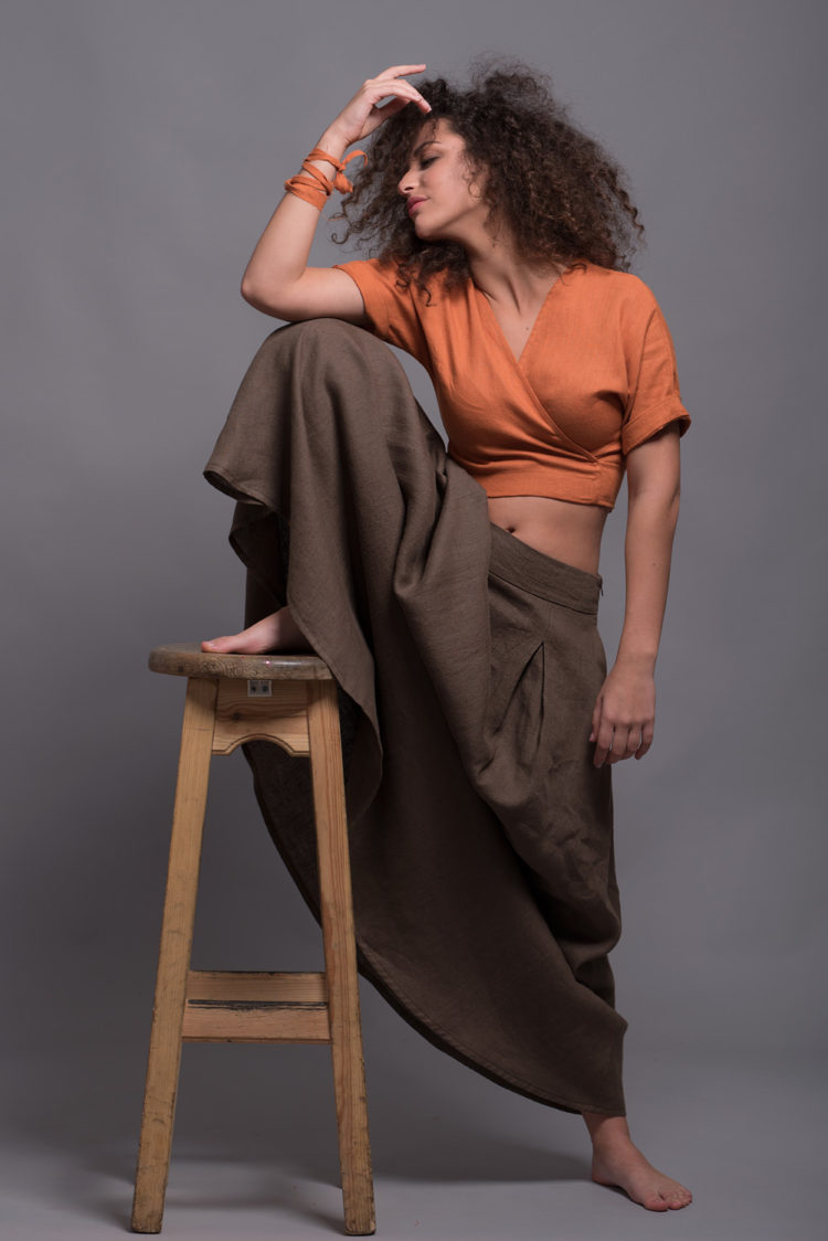 Front view of the wrap linen crop top paired with a flowing skirt.