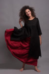 Model wearing the Boho Tiered Maxi Skirt GYPSY in vibrant red, crafted from medium-weight natural linen