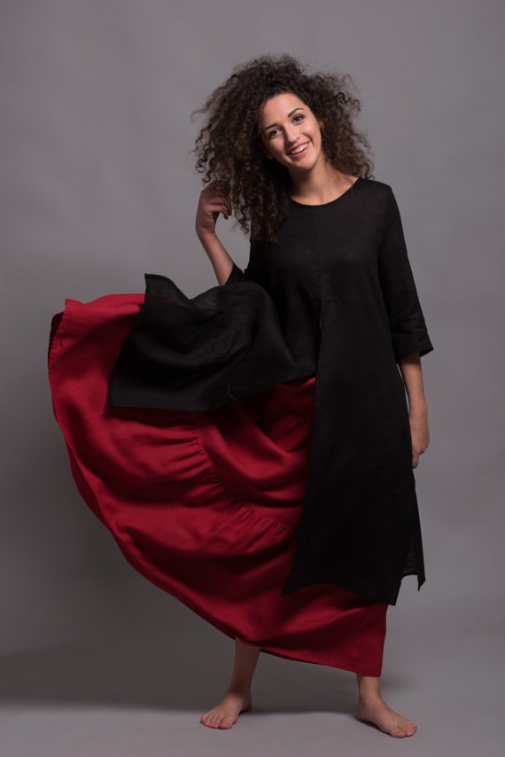 Model wearing the Boho Tiered Maxi Skirt GYPSY in vibrant red, crafted from medium-weight natural linen