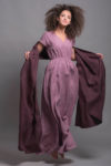 Long linen dress flowing in motion, highlighting its airy and natural fabric.