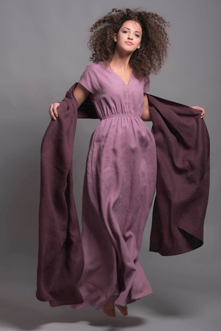 Long linen dress flowing in motion, highlighting its airy and natural fabric.