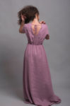Back view of the open-back long linen dress with a delicate tie closure.