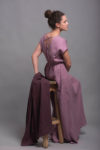 Side angle of the elegant long linen dress, highlighting its short sleeves and flowing shape.