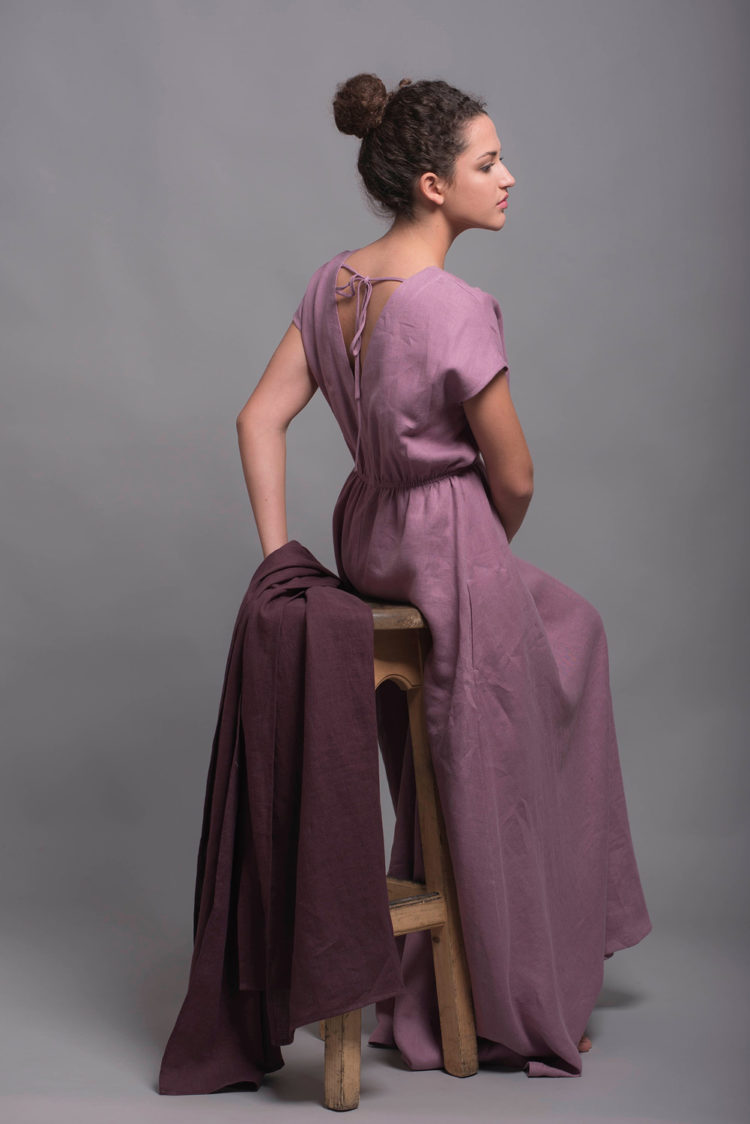 Side angle of the elegant long linen dress, highlighting its short sleeves and flowing shape.