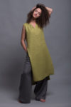 Model wearing the sleeveless flax linen tunic KENI, styled with wide-leg pants.