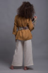 Back view of the YANK Cropped Linen Pants, showcasing the cropped length and streamlined fit. Paired with tied linen waist belt.