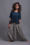 Model moving freely in the relaxed fit FRIDA shirt with casual striped harem trousers, showcasing ease of movement.