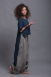 Side view highlighting the dynamic high-low hem and side slits of the FRIDA shirt and Women's Striped Linen Harem Pants NOAH, featuring a relaxed fit and breathable linen fabric.