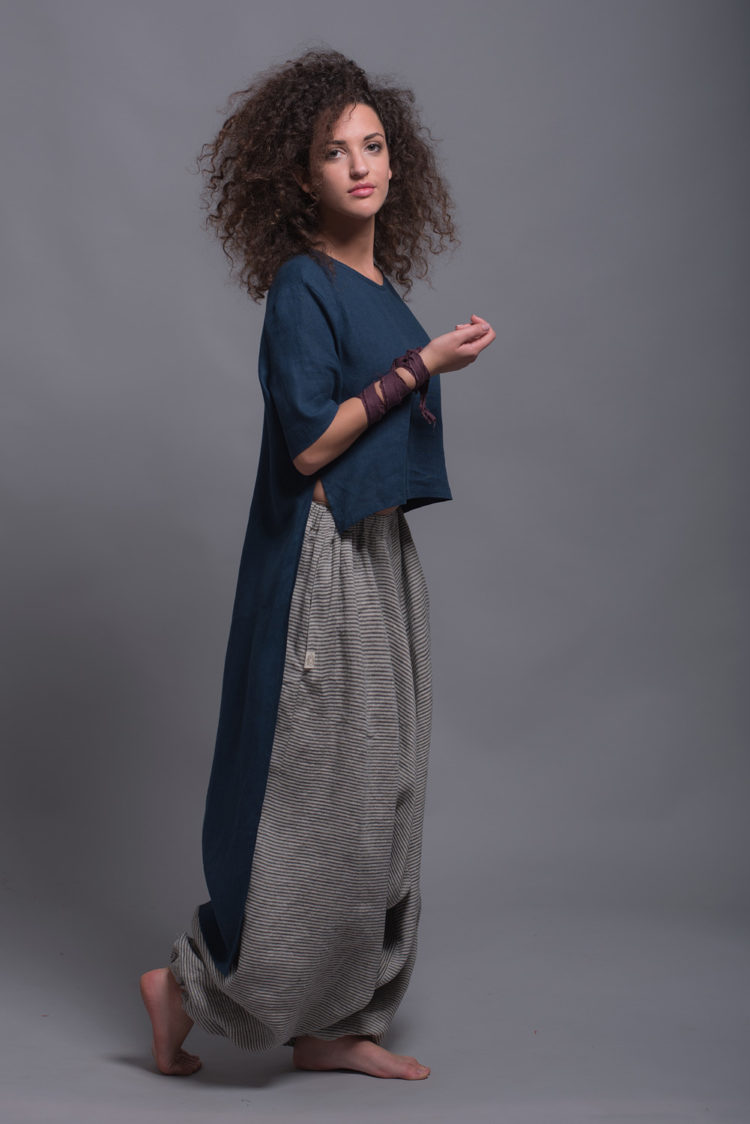 Side view highlighting the dynamic high-low hem and side slits of the FRIDA shirt and Women's Striped Linen Harem Pants NOAH, featuring a relaxed fit and breathable linen fabric.