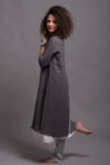 Model in motion wearing the flax linen tunic dress AYA, showcasing the breathable fabric and high slits.