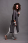 Side view of the linen tunic dress AYA, showcasing the high side slit and knee-length hemline.