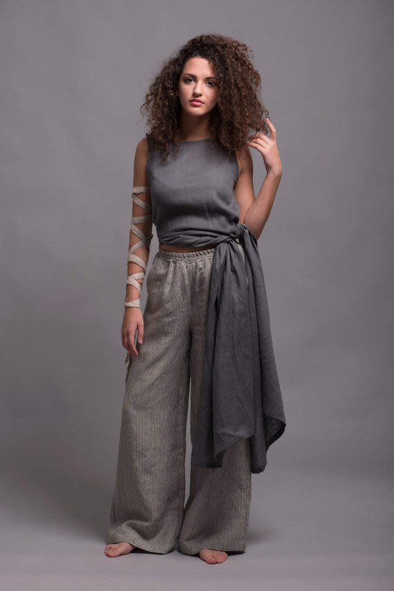 Model wearing mid-rise linen pants, styled casually with a linen top.