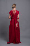 Woman gracefully walking in a red A-line linen dress, ideal for formal occasions.