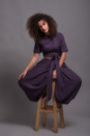 Model wearing a reversible wrap linen blouse in Royal Purple color