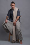 Eco-friendly linen wrap styled for year-round layering, paired with men's striped pants