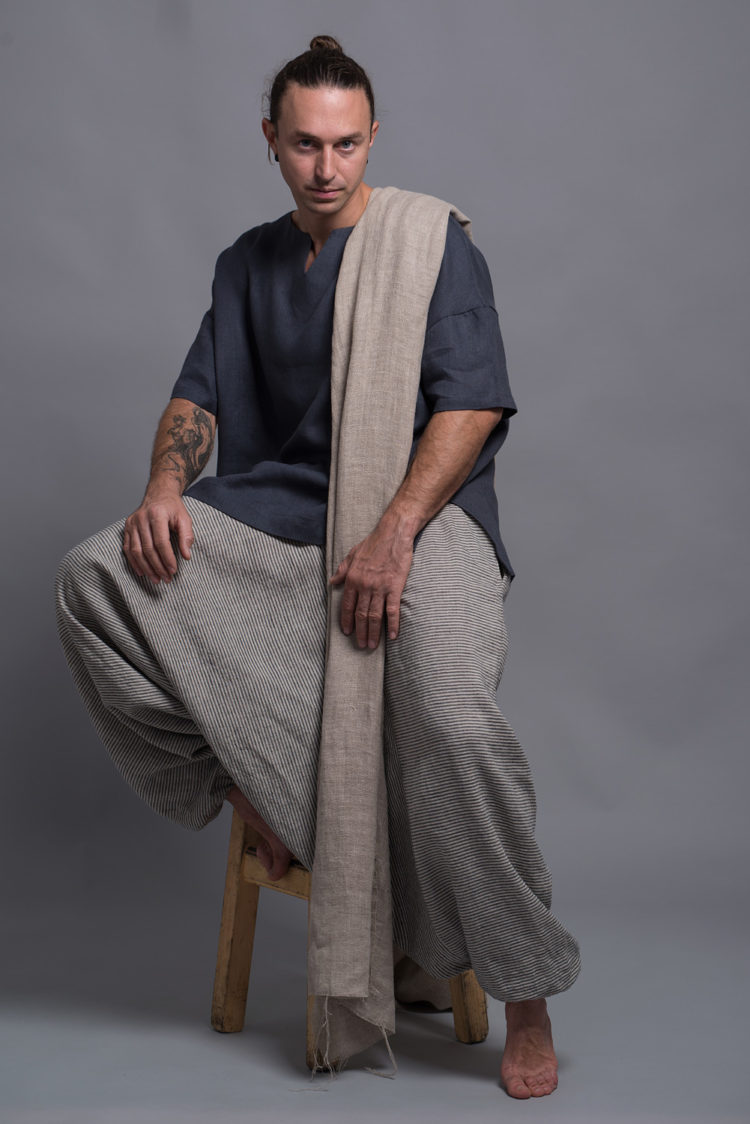 Eco-friendly linen wrap styled for year-round layering, paired with men's striped pants