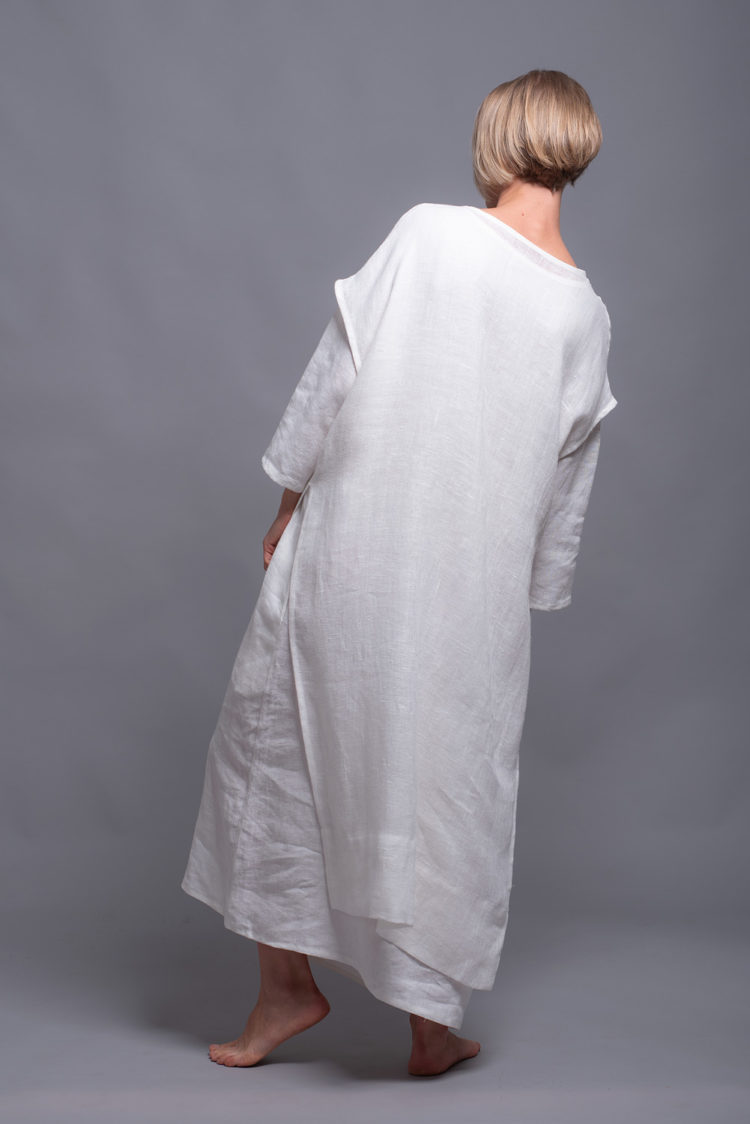 Model wearing the Women's White Linen Tunic SANGA layered over white linen dress.