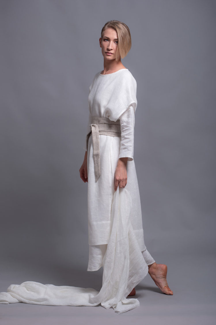 Model showcasing the tunic's versatility in movement, styled casually with accessories.