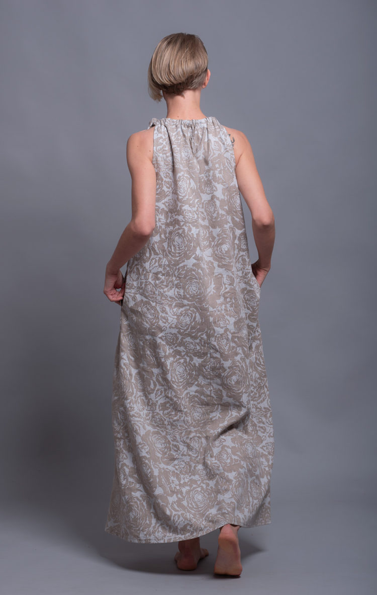 Back view of the linen dress, displaying the open-back design with an adjustable tie.