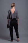 Back view of linen tapered trousers featuring an elasticated waistband for comfort.