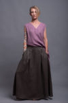 Woman in a natural flax linen maxi skirt, perfect for all-season styling.