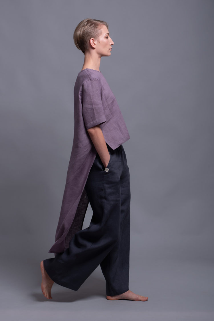 Model styling the BORA Linen Pants in Charcoal Gray, showing the wide-leg fit and minimalist design