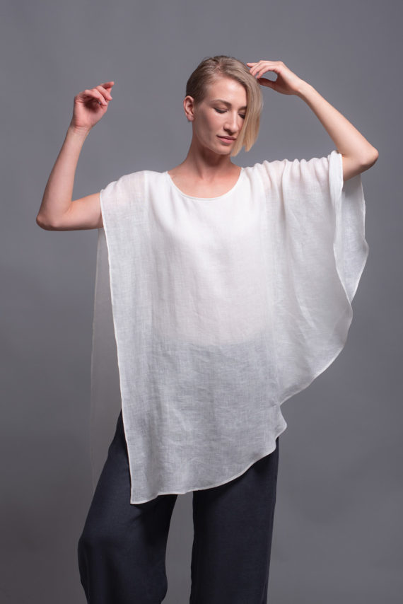 Sleeveless fitted tank under-layer of the white linen top shown close-up.
