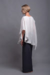 White two-layer linen top styled with linen pants for a casual summer outfit.
