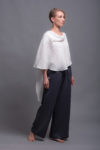 Front view of the round neckline and layered construction of the white linen top.