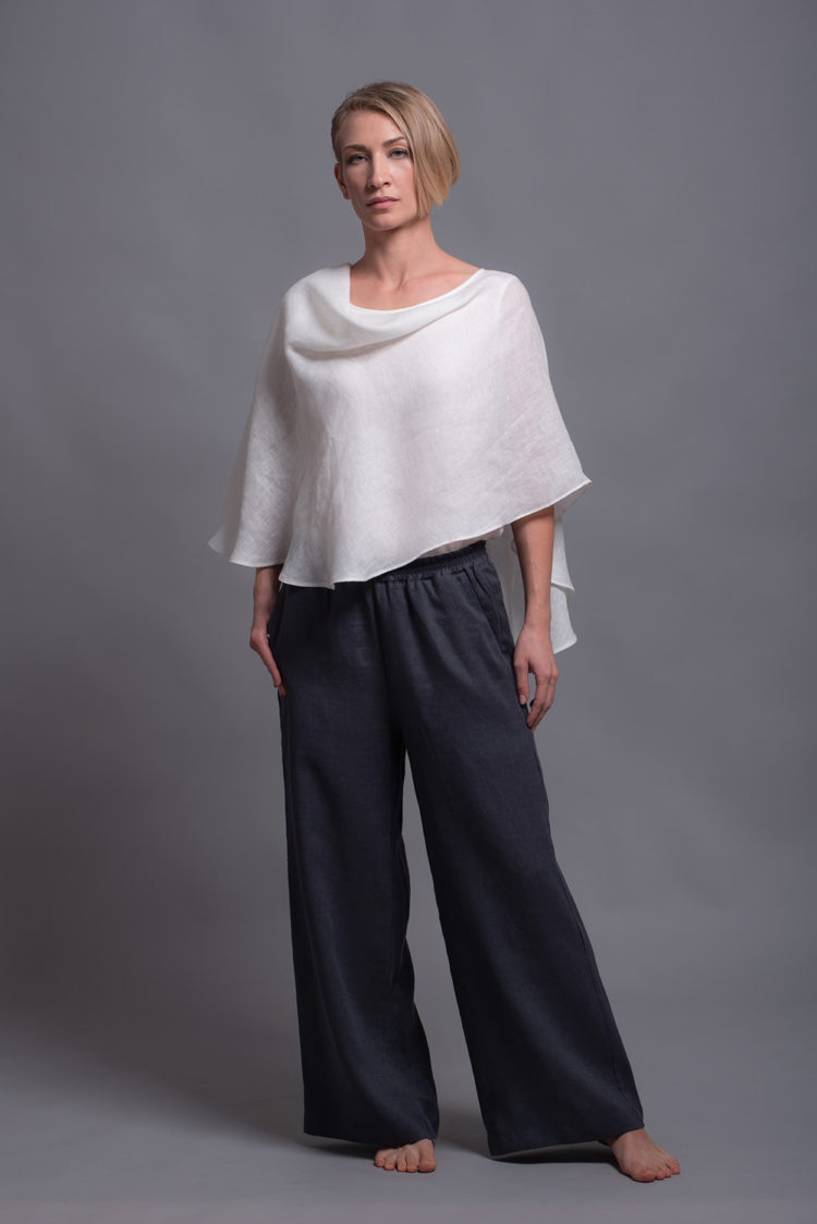 Model styling the BORA Linen Pants in Charcoal Gray with white top, showing the wide-leg fit and minimalist design