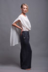 White two-layer linen top with a loose cover and round neckline displayed on a model.