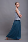 Side view of the MAHA tank top, showcasing the smooth, breathable linen fabric and hip-length hem.