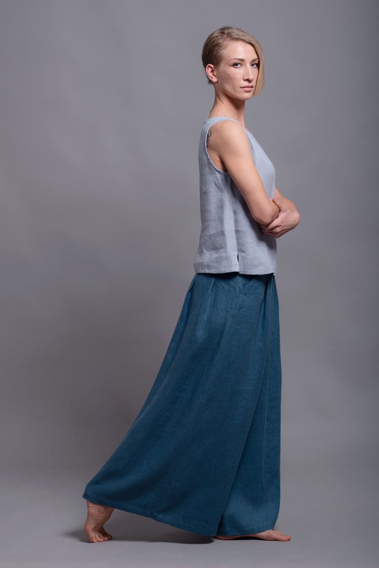 Side view of the MAHA tank top, showcasing the smooth, breathable linen fabric and hip-length hem.