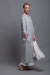 "Model wearing the NIKA dress layered with the white OLA underdress, perfect for a chic, minimalist look.