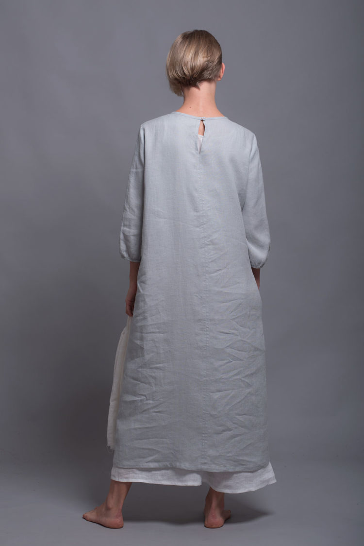 Back view of the silver gray NIKA dress, highlighting its straight hemline and three-quarter length sleeves.