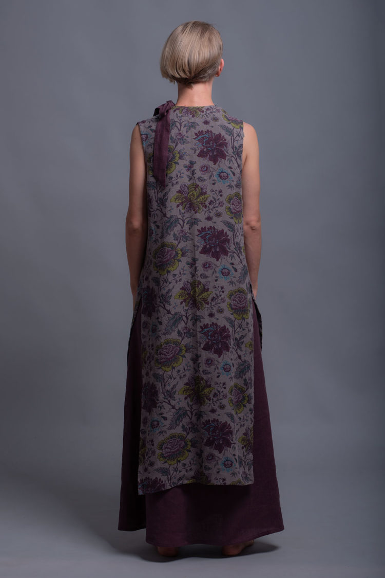 Back view of the sleeveless linen cardigan showcasing its lightweight drape.