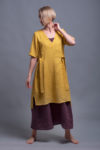 Model walking in the linen tunic dress ELLA, showing ease of movement and a flattering fit.