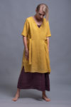 Model wearing the linen tunic dress ELLA styled with linen dress for a layered look.