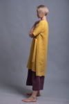Side view highlighting the asymmetrical hemline and long side ties of the ELLA tunic dress.