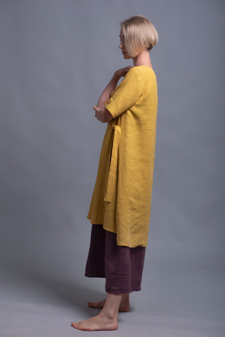 Side view highlighting the asymmetrical hemline and long side ties of the ELLA tunic dress.