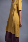 Close-up of the half sleeves and small side slits on the linen tunic dress ELLA.