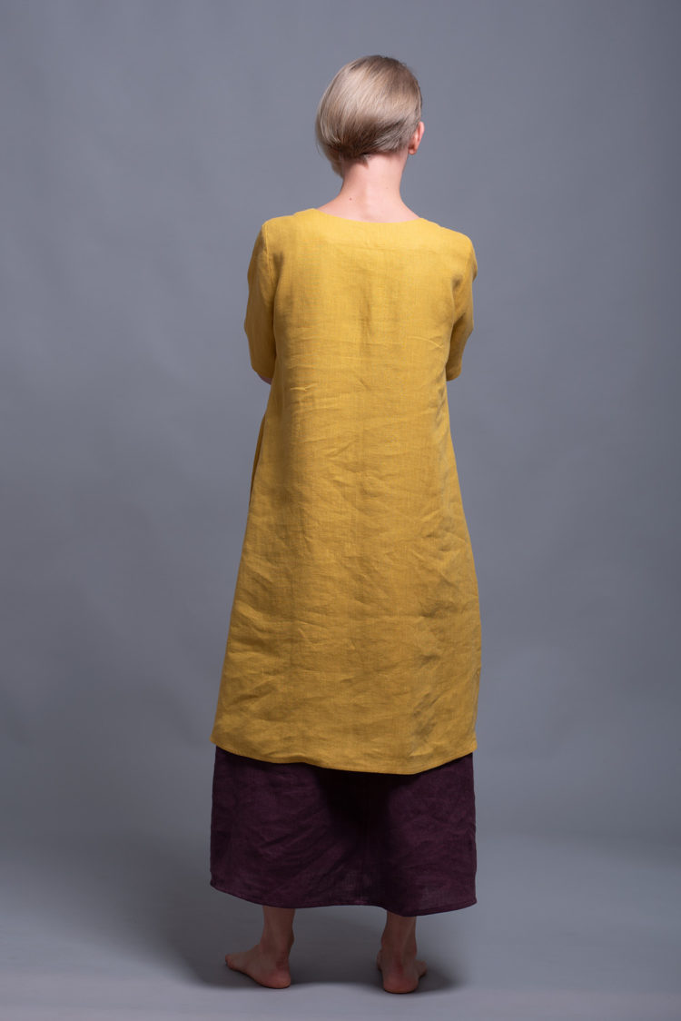 Back view showcasing the flowing, breathable medium-weight linen fabric of the tunic dress.