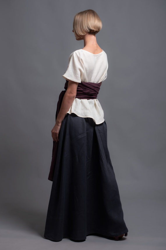 Side view of the linen top TOD, highlighting rounded hem design.