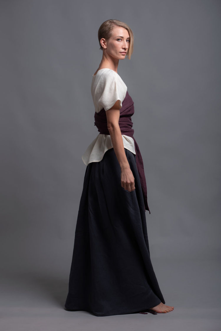 Model showcasing the versatility of the linen top TOD styled with accessories.
