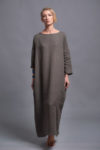 Woman posing in a long linen dress, embodying effortless style and comfort