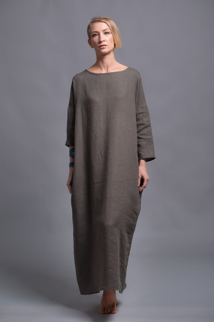 Woman posing in a long linen dress, embodying effortless style and comfort
