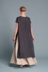 Lightweight sleeveless linen tunic worn by a model, showcasing its airy design and asymmetrical hem