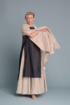 Unisex lightweight linen shawl in natural flax, draped over shoulders