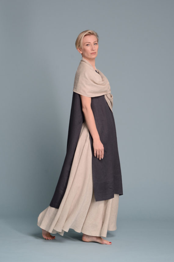 A model wearing the PERAH linen skirt, styled with a tucked-in blouse for an elegant look